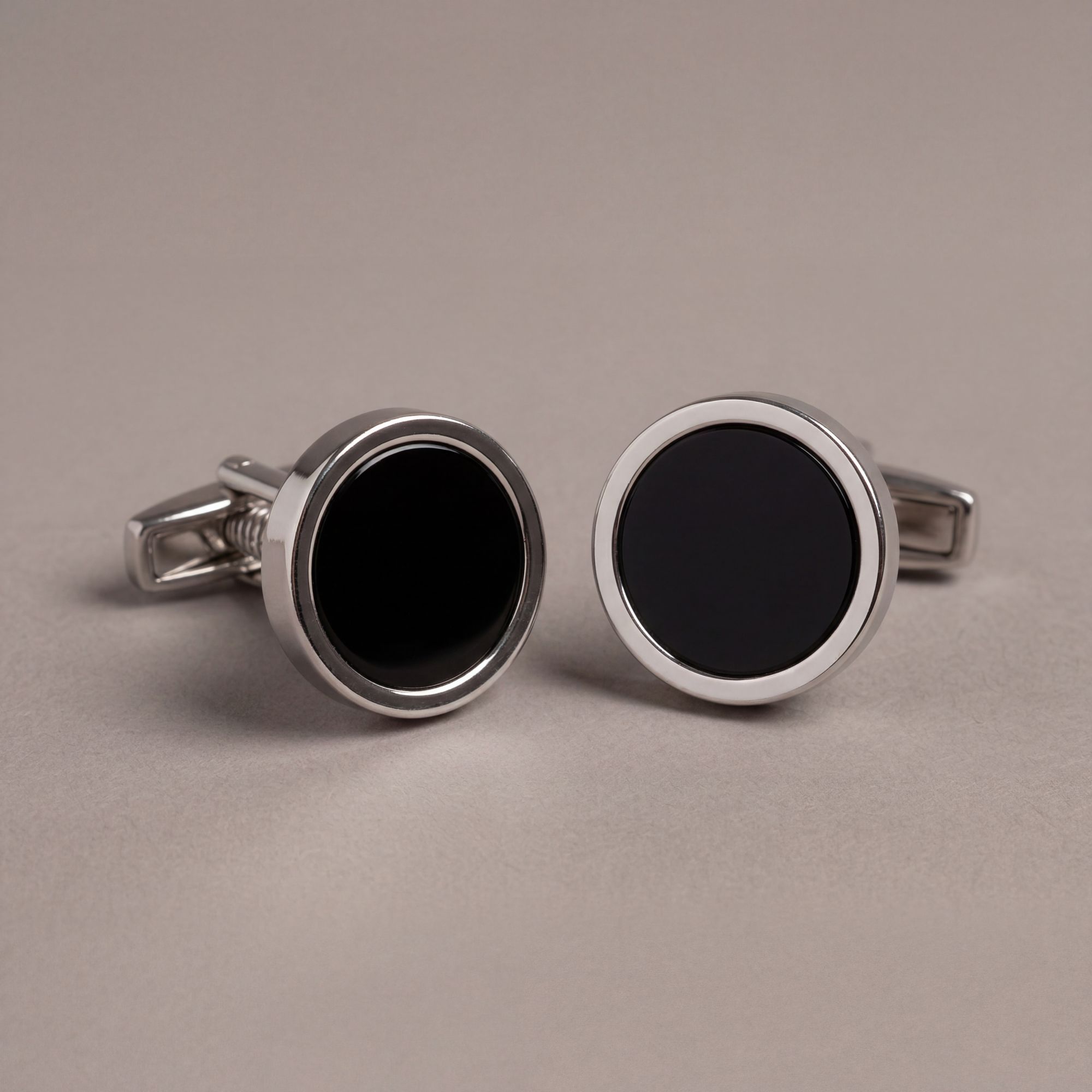 Black steel cufflinks with an onyx-look centre and polished frame. Refined formal detail in premium menswear by Elio Eva