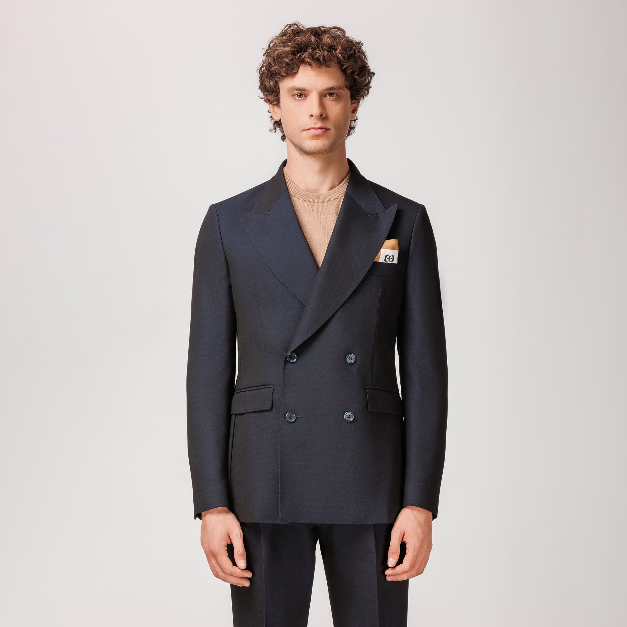 Navy double-breasted blazer by Elio Evan, crafted from a sustainable lyocell and virgin wool gabardine blend with peak lapels and half-lined construction.