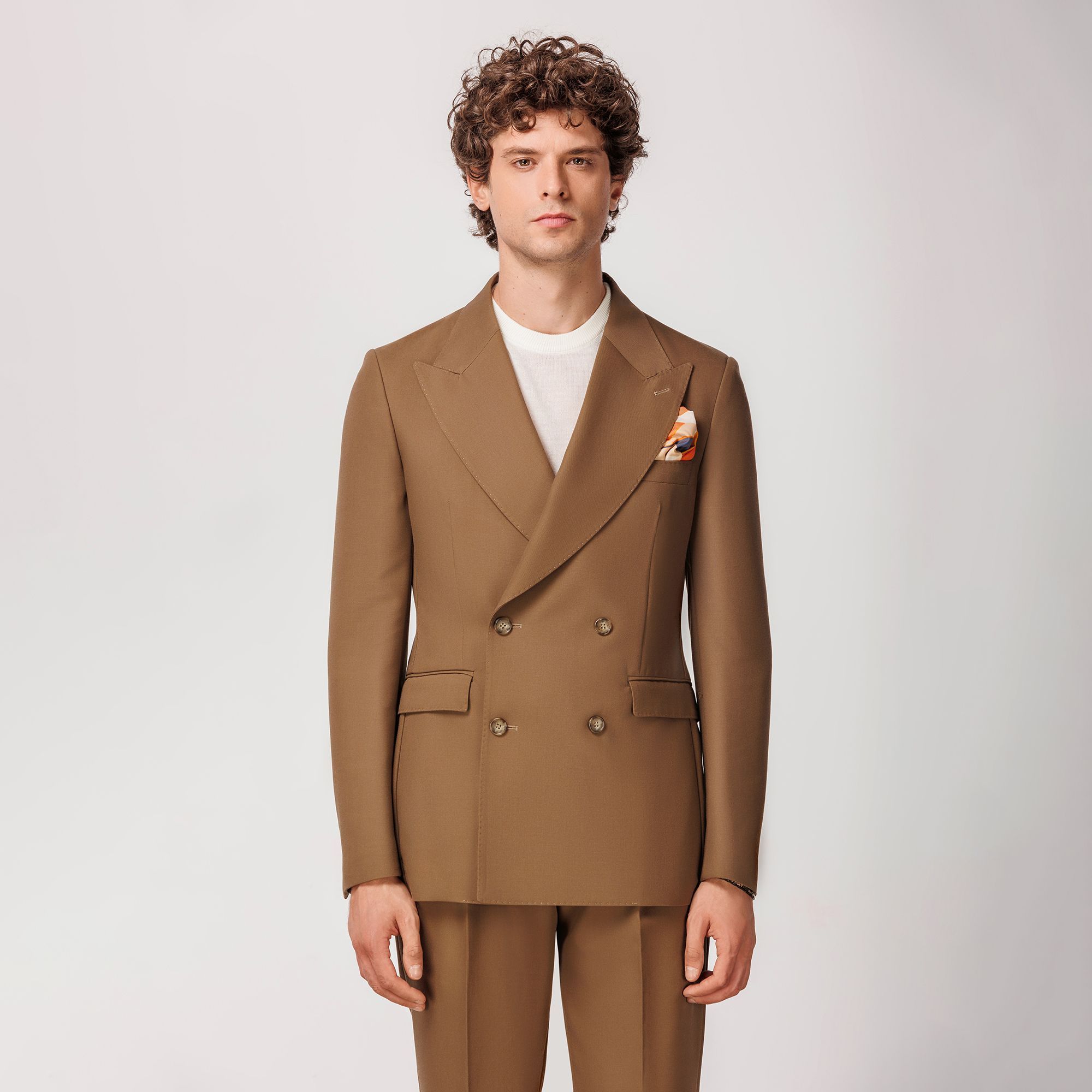 Camel double-breasted blazer by Elio Evan, crafted from a sustainable lyocell and virgin wool gabardine blend with peak lapels and half-lined construction.
